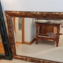 Large Mirror. Frame is a goldish brown color.