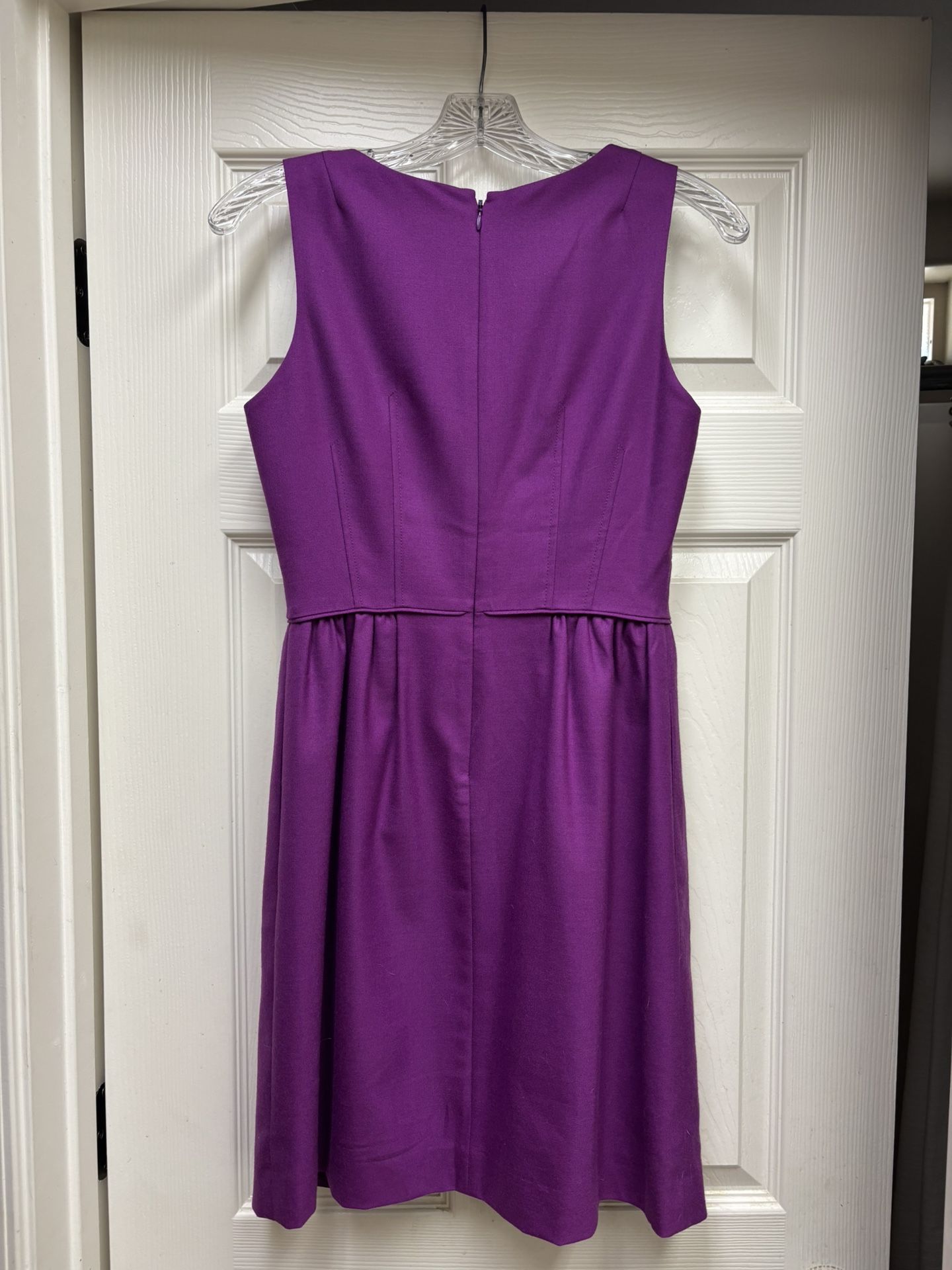 This stunning J. Crew dress in a rich purple hue features a pleated design that adds a touch of elegance to its sheath silhouette. Perfect for cocktai