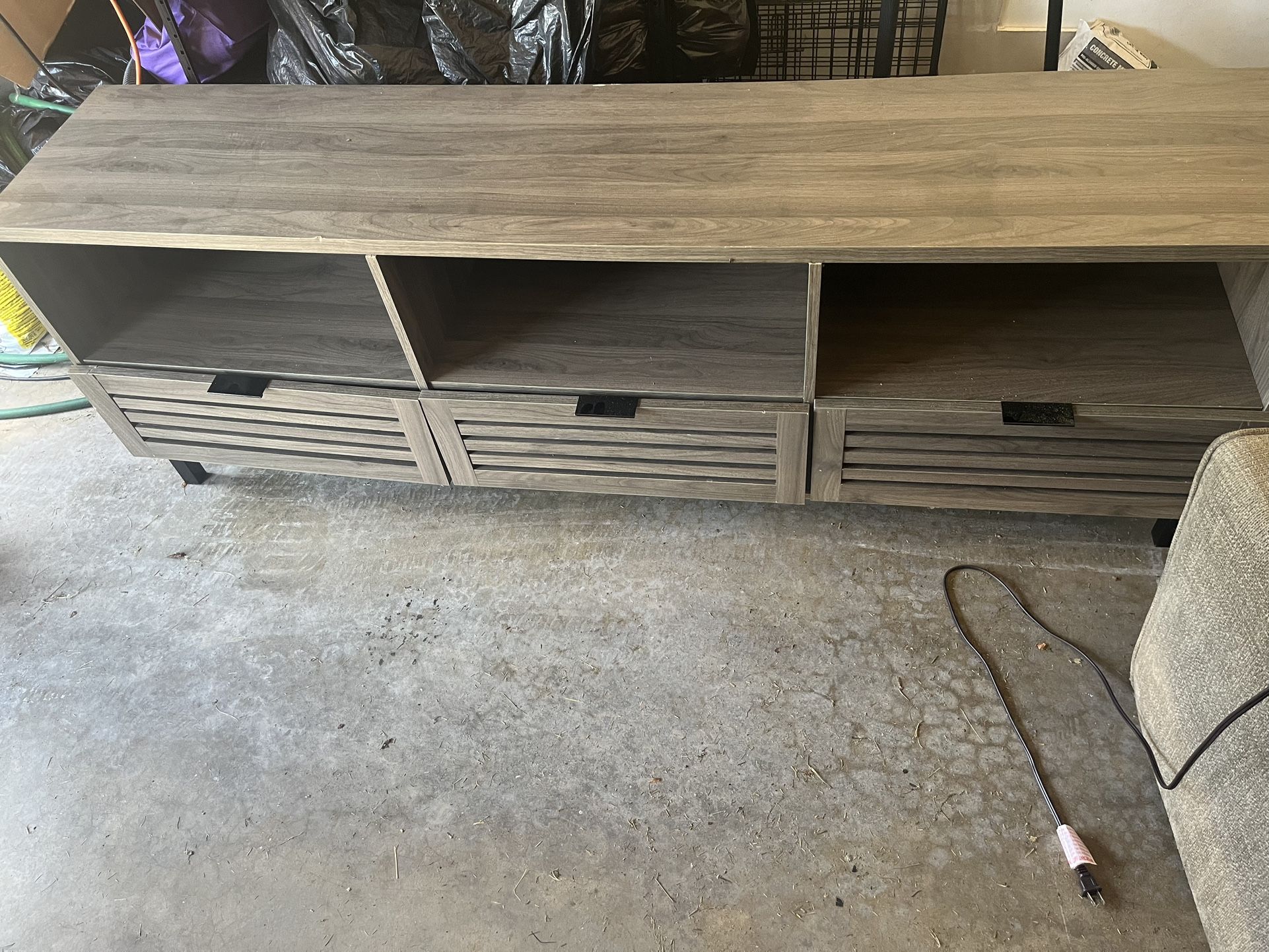 To end tables and a 70 inch TV stand and another wooden table