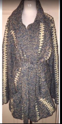 This is a true hippie jacket cardigan sweater made by kennington. There are no rips or TEARS. It also has two pockets on the on the front of the jack