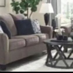 Ashley Signature Design Nemoli - Sofa& Loveseat   Taupe $1500 This sofa sets the scene for a modern space full of casual flair. Its textured chenille 