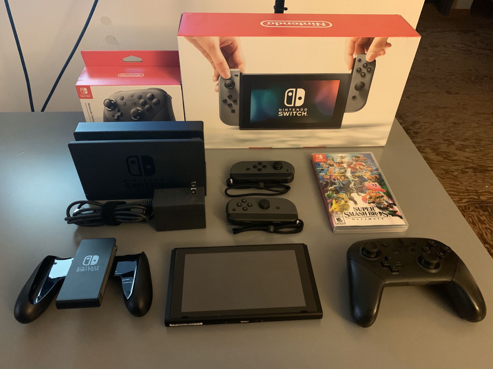 Grey Nintendo Switch with Nintendo Switch Pro Controller and Super Smash Brothers Ultimate