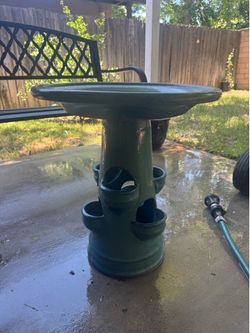 Beautiful ceramic glazed birdbath. Area to place plants