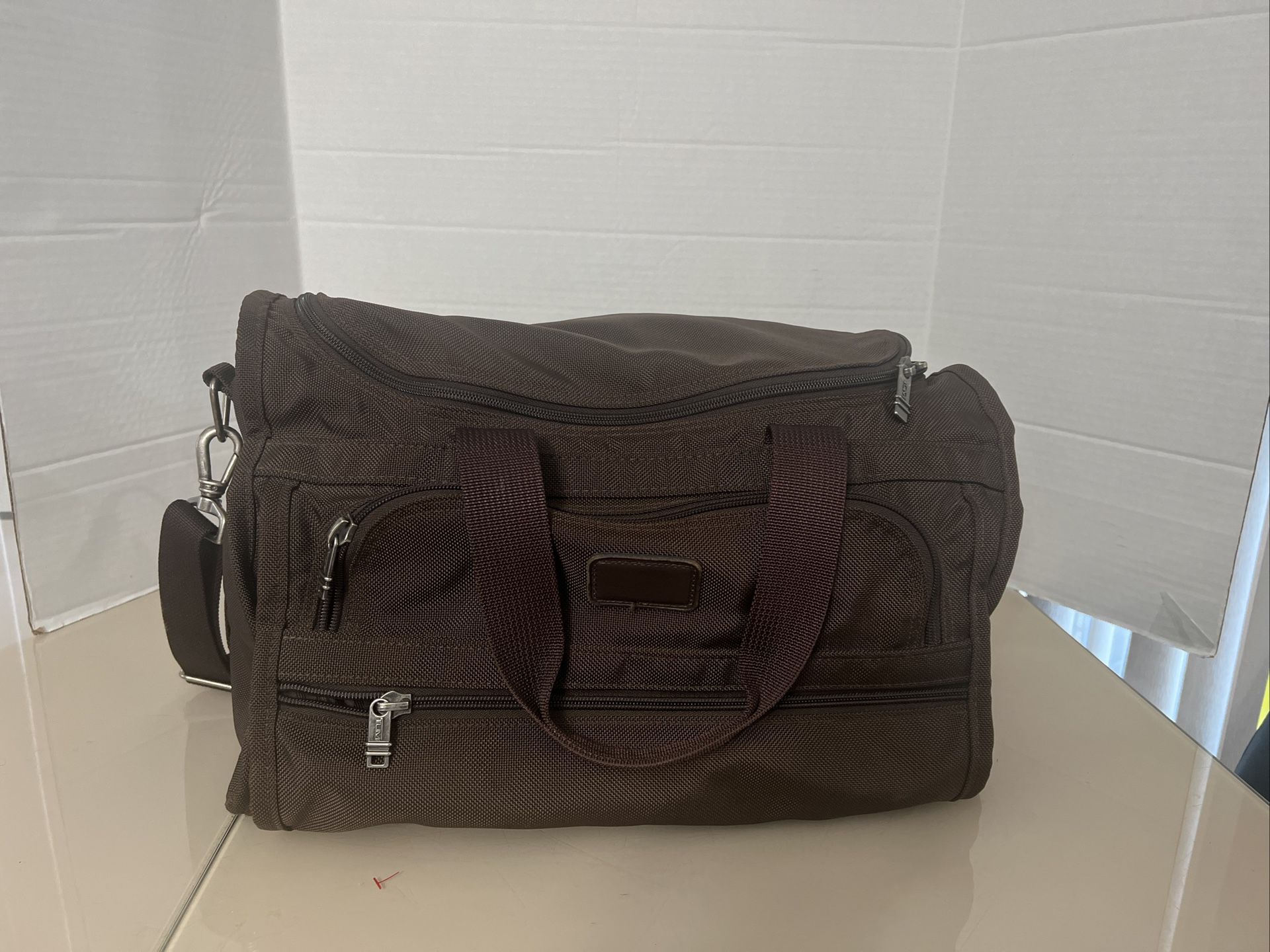 TUMI Brown Carry On Messenger Bag With Shoulder Strap USA Excellent Condition. The bag has been very gently used and in very good condition. It’s choc