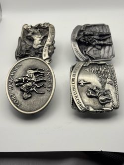 A multiple vintage fort Huschuca Arizona belt buckle commemorative featuring