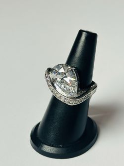 Silver and rhodium ring; white teardrop-shaped cubic zirconia with small crystals; beautiful design.