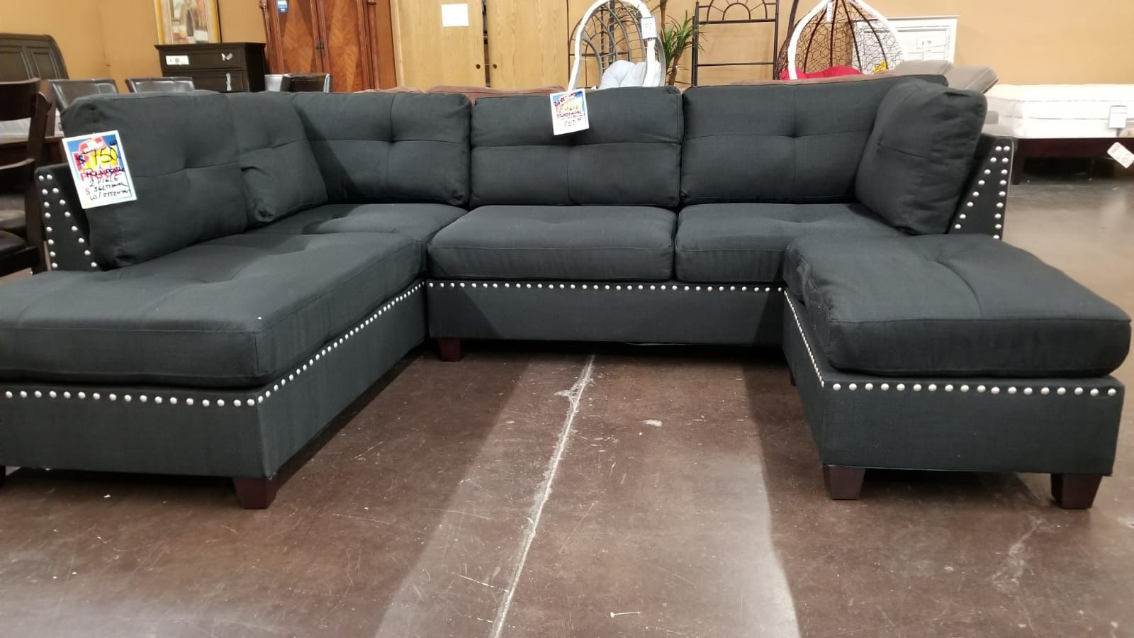 Traditional black pinhead reversible sectional with a matching ottoman
