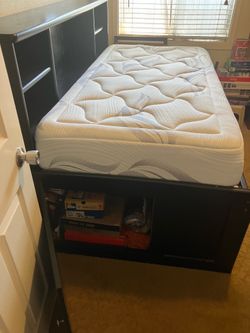 Bed with mattress included and storage.
