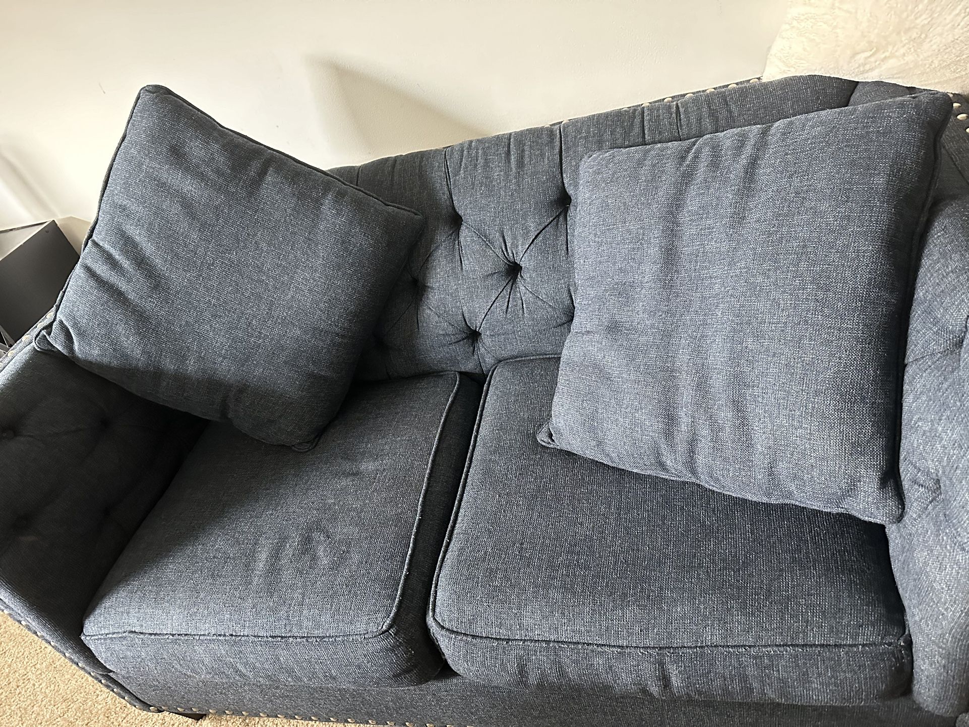 Blue couch with pillows