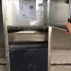 Recessed paper towel dispenser with a trash can