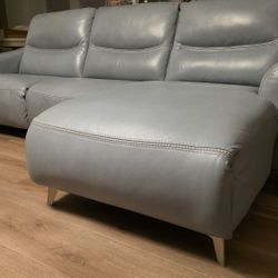Power Reclining Couch. PU Leather. Stone blue color. Bought at Rooms To Go. Great shape. Local pickup only. Must carry out yourself.