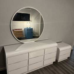 White Modern Dresser With Big Circular Mirror And Bedside Nightstand