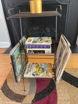 Vintage Mid Century Modern 3 Tier Wire Metal Shelf. Great for holding plants, magazines and records. It is weathered and rusty from being outside but