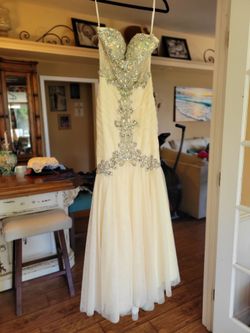 Gorgeous Prom /special occasion dress. Size XS, made with pale apricot mesh and  very ornate with beads and gems.  Very flattering and certain to stan