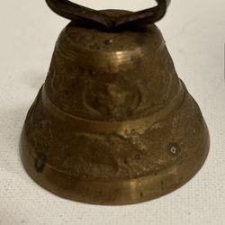 Antique bronze bell with a house, a man and a cow