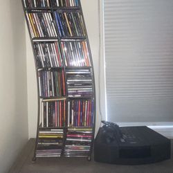 3 PIECE BUNDLE DEAL LOT/1- BOSE FM/AM CD PLAYER STEREO/1-METAL CD TOWER RACK, AND A LITTLE OVER 250 FULL TRACK CDS OF DIFFERENT MUSIC GENRE.
