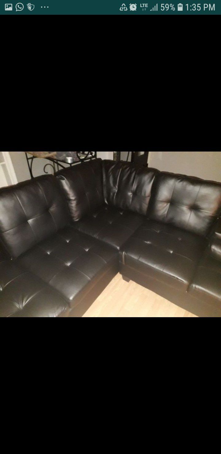 Brand new sectional black couch with black ottoman