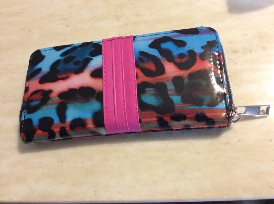 Wallet, USED, NOT LEATHER, 7 1/2 inches long by 4 inches wide, zip across top, meet at Exxon at 2428 E Lamar Alexander parkway Maryville