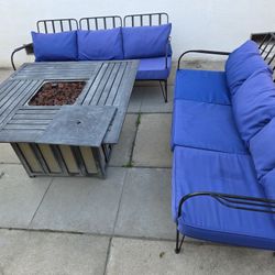 Set of two sofas with a gas fire table and cushions.