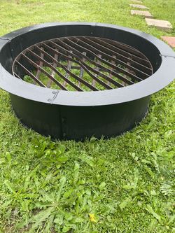 Wrought iron fire pit solid  - Fire pit with grill is iron and the liner - no bricks - liner is 33.5  inches wide 10 inches high can do higher with br