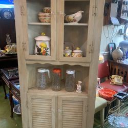 32x22x69 vintage corner cabinet. Fits in corner of room.  165.00 Top and bottom storage.  No glass on top doors.  Johanna at Antiques and More. Locate