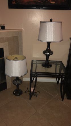 Two lamps and a glass table
