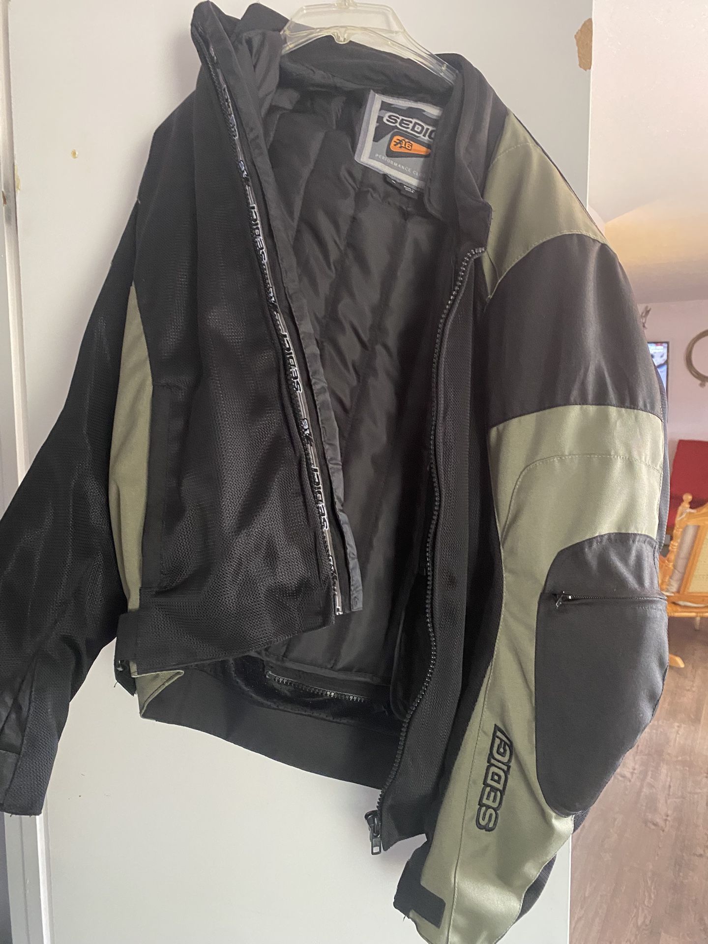 Sedici motorcycle jacket. Green and black. Barely used. Medium. Winter liner that’s removable, and elbow pads.