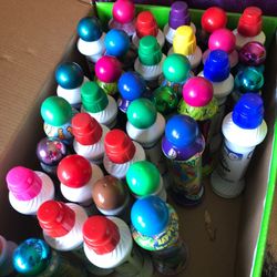 Lots of bingo paint bottles most of them are full about 37 bottles