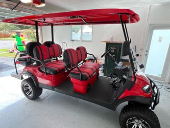 Red 6-Passenger Golf Cart with Lifted Suspension