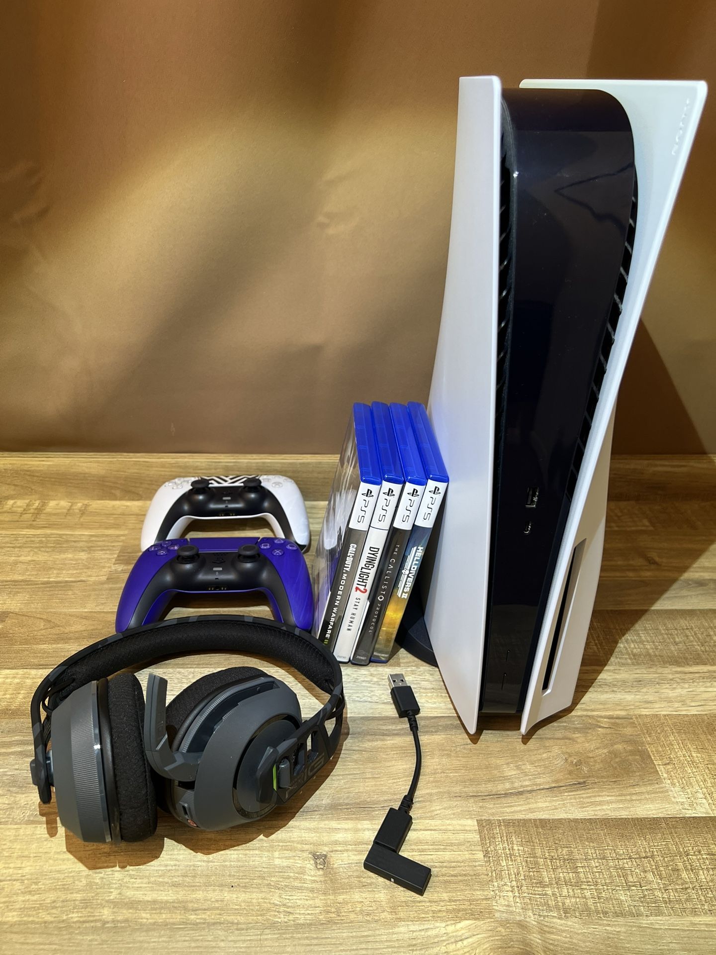 PlayStation 5 with 2 Controllers, RIG Wireless Headset & 4 Games (MW2, Helldivers 2, The Callisto Protocol, Dying Light 2)