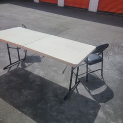 Folding table and 2 chairs.