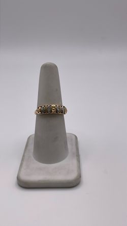 14k gold band ring with CZ around it