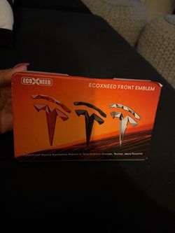 Ecoxneed Front Emblem box featuring angular, faceted " replacement  logos for Tesla vehicles