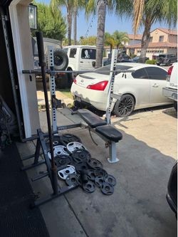 Bench press/squat rack with 7ft 45lbs bar plus 270lbs of Olympic weights and weight tree and 5ft bar