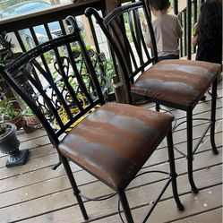 2 bar stools with new seat covers snake brown design. 