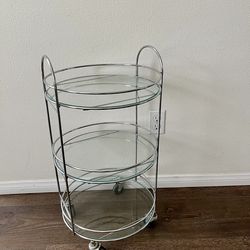 A chrome  tubular frame and three circular shelves organizer 25 inches tall