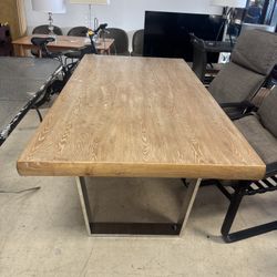 Beautiful industrial-style dining table featuring a solid wood top paired with U-shaped metal legs - Retail: $1599