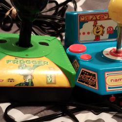 Two Video Games One Is Frogger And The Other One Is Ms.Pac Man , Pole Position, Galaga, Mappy, And Xevious 