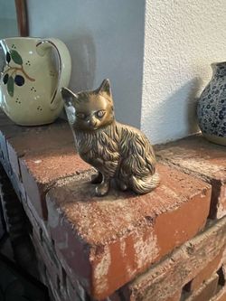 vintage solid brass cat figurine featuring finely textured, long-haired fur detailing. [1] (https://offerup.com/redirect/?o=aHR0cHM6Ly93d3cuZXRzeS5jb2