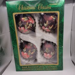 Add some vintage charm to your Christmas decorations with this set of 4 hand-decorated glass ornaments from Christmas Classics. The round ornaments co