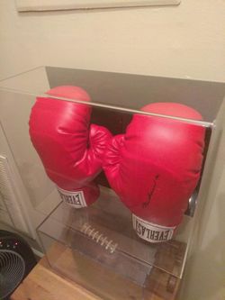 Authentic hand signed Muhammad Ali everlast boxing gloves in UV protected display case has numberd certified hulagram