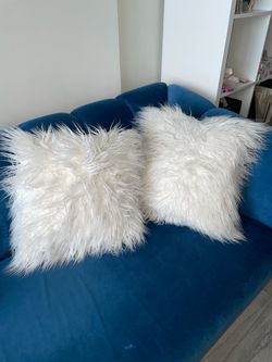 Two decor white fur pillows