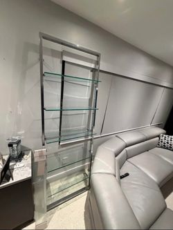 These are two glass shelves, like new. They come with extra replacement glass panels. Excellent quality. Both for $200.