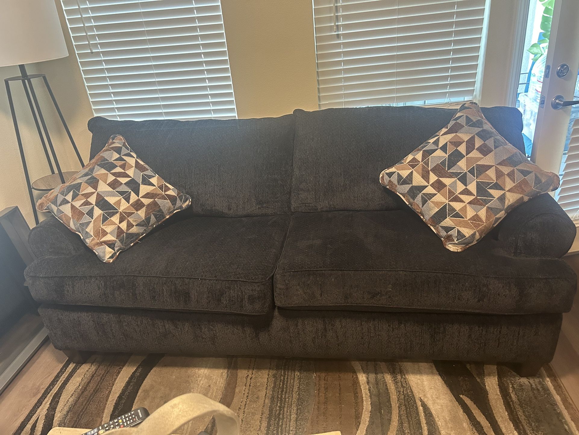Couch And large chair with pillows Made By Broyhill And rug.