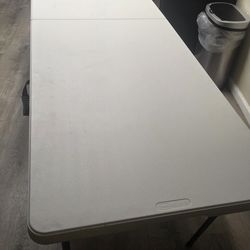 Folding table with a reinforced central heavy leg and 8 chairs. 8ft Table.