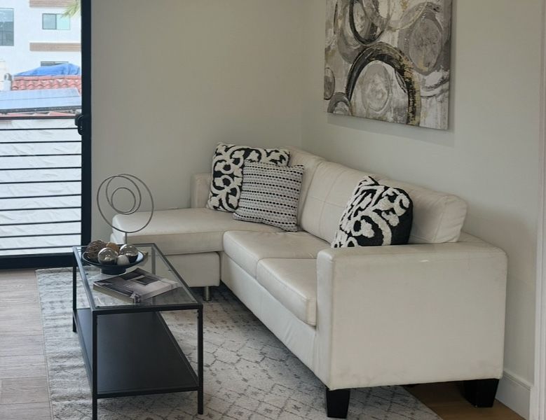 White Leatherette Sofa With Ottoman/Chaise