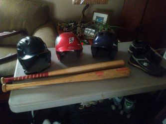 Baseball helmets two bats and a pair of size 9 cleats