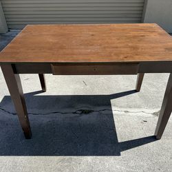 Brown wooden table with pullout tray