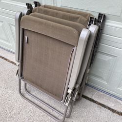 Four Metal folding chairs