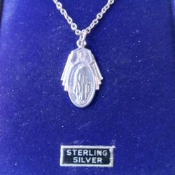 Sterling Silver Miraculous Medal on an 18 inch Stainless Steel Chain. Sacred Heart of Jesus also depicted on front. Religious jewelry.